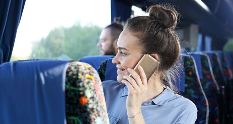 Passenger speaks on the phone while traveling.