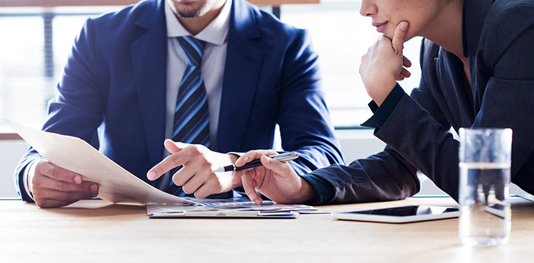 Two business men looking at a contract