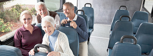 Passengers on a bus smiling