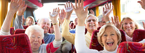 Group of bus passengers with their hands in the air