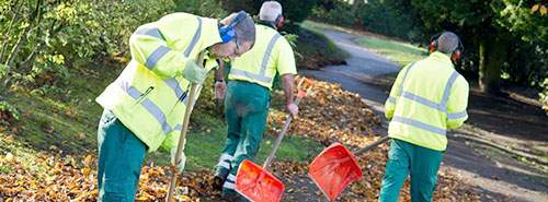 Workmen landscaping in a park area